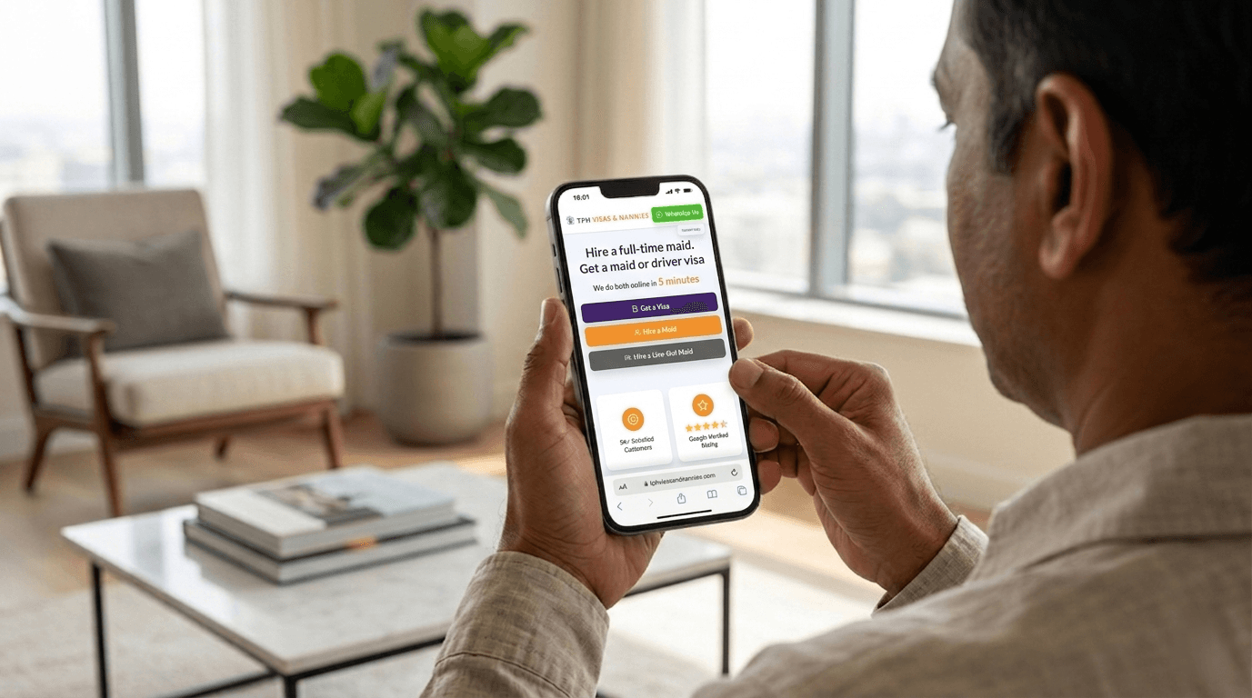 Man using a smartphone at home to hire a maid in Dubai through an online agency platform.